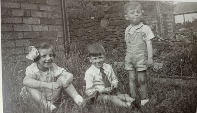Owain Arwel Hughes with his sister and brother in the back garden of 1 Colchester Avenue